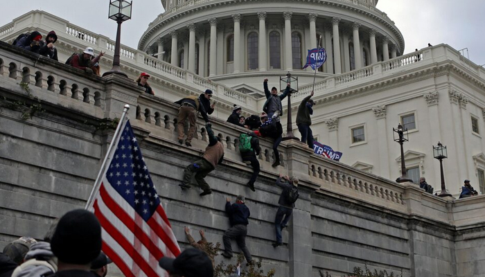 Supporters of Donald Trump climb a wall during a protest against the certification of the 2020 presidential election results by the Congress, at the Capitol in Washington on January 6, 2021. — Reuters