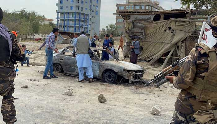 Afghan men take pictures of a vehicle from which rockets were fired, as Taliban forces stand guard, in Kabul, Afghanistan August 30, 2021. — Reuters/File