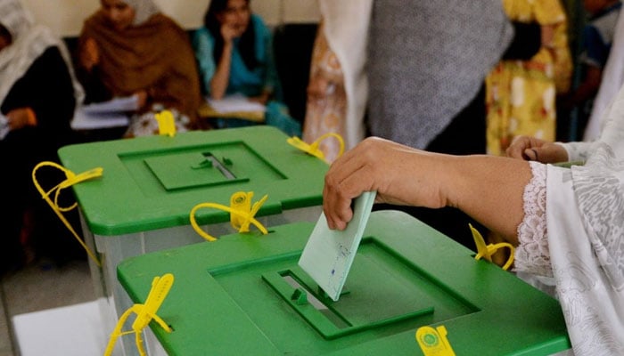 In this undated photo, a voter is seen casting her vote into a ballot box. — AFP File