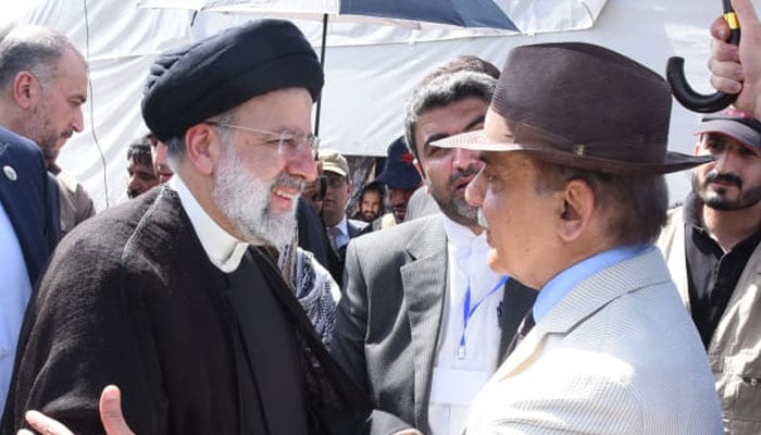 Iranian President Ebrahim Raisi (left) interacts with Prime Minister Shehbaz Sharif. — X/@PakPMO/File