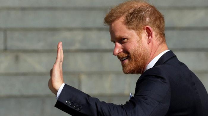 Prince Harry forcibly wedging a foot back into the royal door