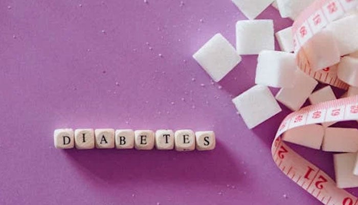 A representational image showing 'Daibetes' written with sugar cubes and a measuring tape on the side. — Pexels