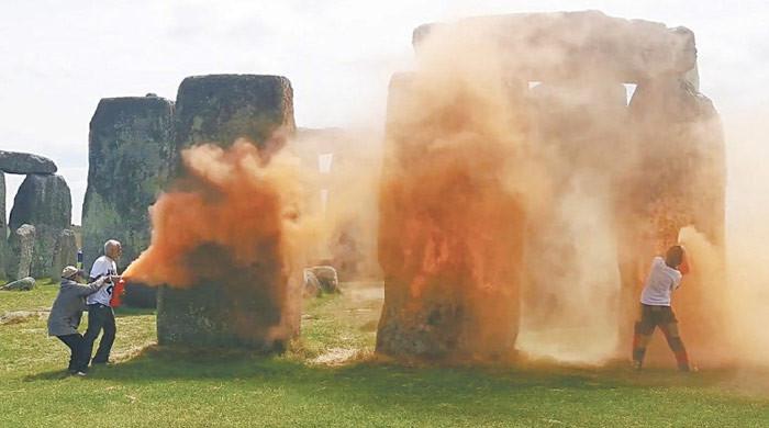 Iconic Stonehenge monument orange spray-painted by climate protestors M Haris