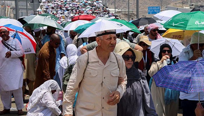 Muslim pilgrims walk with umbrellas on the third day of the devil stoning ritual, amid extremely hot weather, during the annual haj pilgrimage, in Mina, Saudi Arabia, June 18, 2024. — Reuters