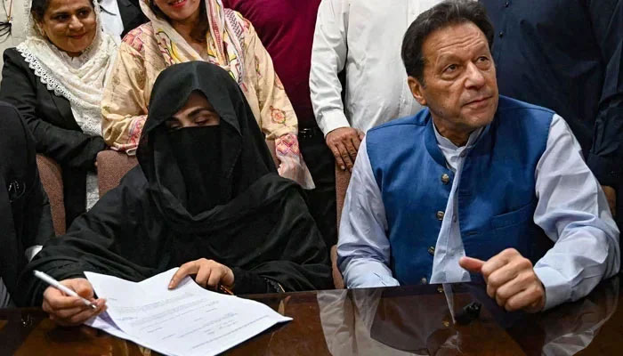 PTI founder and former prime minister Imran Khan pictured alongside his wife Bushra Bibi at LHC in this undated image. — AFP/File