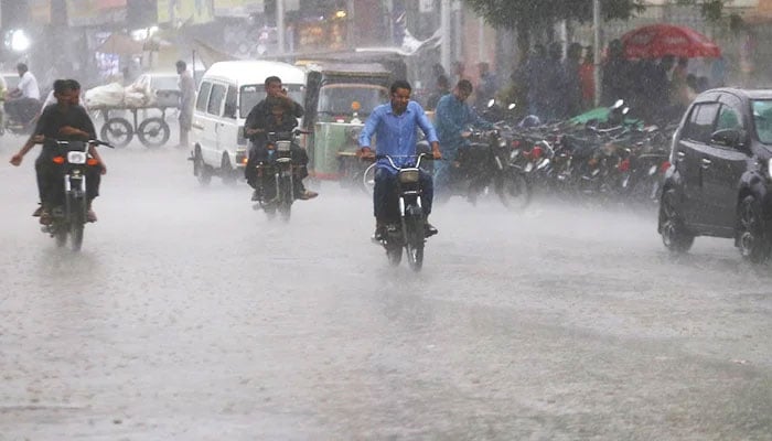 Motorcyclists commuting amid rain in Karachi, on September 20, 2023. — INP