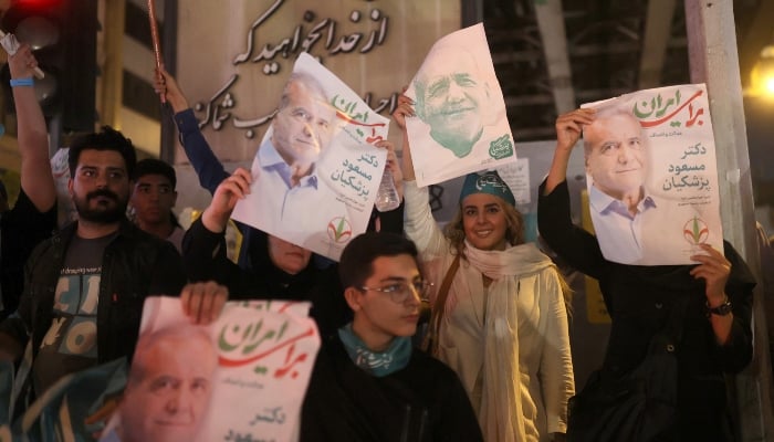 Supporters hold posters of Iranian presidential candidate Masoud Pezeshkian during a campaign event in Tehran, Iran, on June 26, 2024. —Reuters