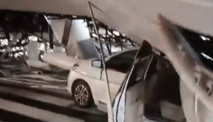 A car smashed by the collapsed Delhi airport roof. — Screengrab via X/@ANI