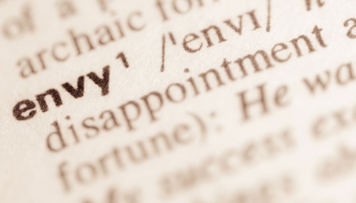 A representational image of envy as seen in a dictionary. — Canva