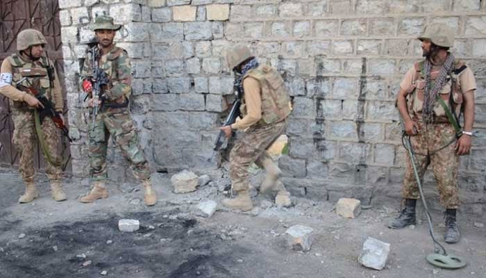 Security forces are seen taking position during an operation at an undisclosed location. — ISPR/File