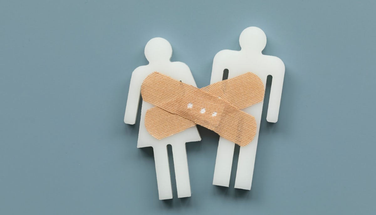 A representational image showing a couple fixed by a band-aid. — Canva