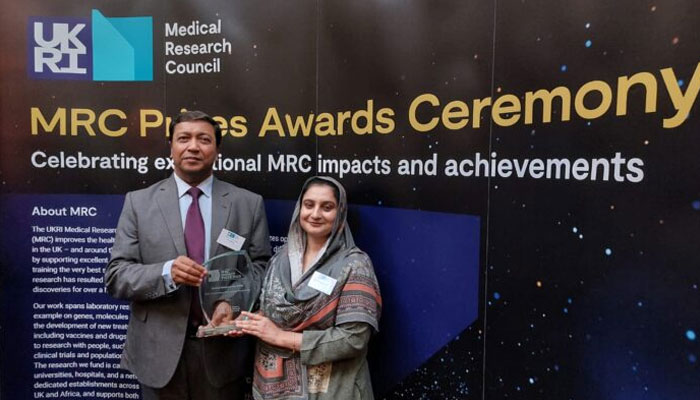 Prof Dr M Iqbal Choudhary (left) and Prof Dr Sammer Yousuf gesture for a photograph as they hold the“Outstanding Team Impact Prize” from UKs Medical Research Council (MRC). — APP