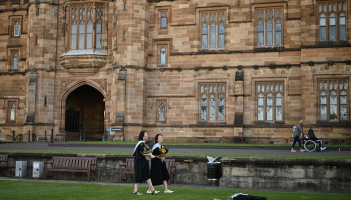 International students from China wear graduation gowns as they take pictures around the University of Sydneys campus in Sydney, Australia, July 4, 2020. — Reuters