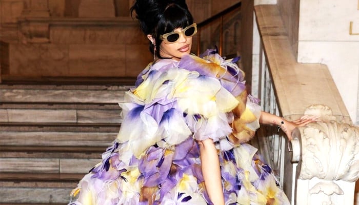 Cardi B steals the show with her feathered songbird dress and white boots at Marc Jacobs Fashion Show