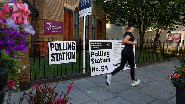 A person runs past a polling station shortly before the polls open and voting begins in the UK general election in London, Britain, July 4, 2024. — Reuters
