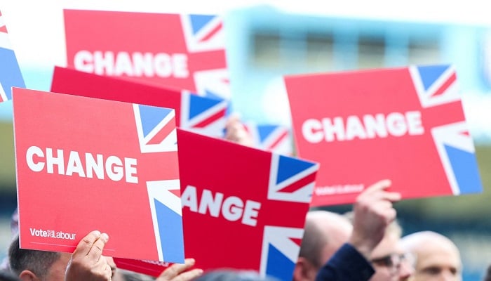 Supporters of UKs Labour Party hold placards reading Change during election campaign in this undated photo. — Reuters