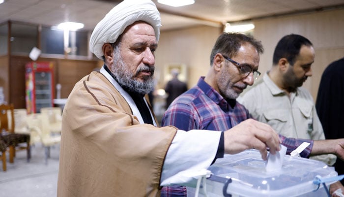 An Iranian voter participates in the runoff presidential election between Masoud Pezeshkian and Saeed Jalili, at the Iranian consulate in Najaf, Iraq, on July 5, 2024. — Reuters