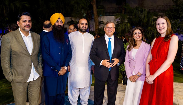 United States Ambassador to Pakistan Donald Blome poses for a picture with members of religious minorities and US Consul General Lahore Kristin K Hawkins. — Supplied