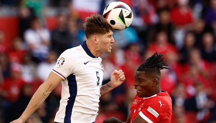 England’s defender #05 John Stones fights for the ball with Switzerland´s forward #07 Breel Embolo (R) during the UEFA Euro 2024 quarter-final football match between England and Switzerland at the Duesseldorf Arena in Duesseldorf on July 6, 2024. — AFP