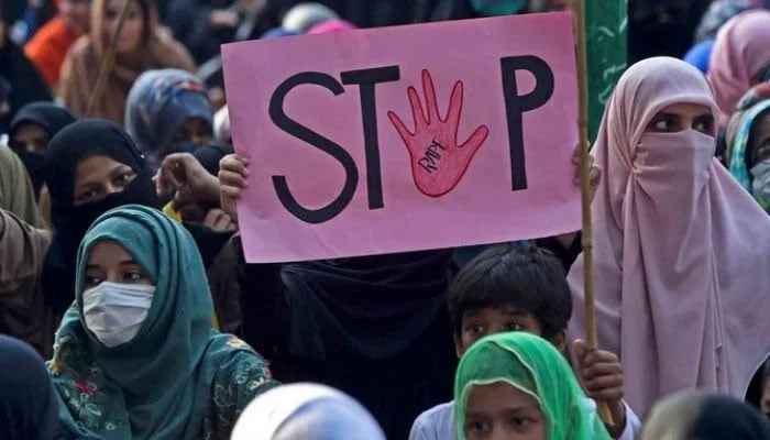 Woman holding a placard reading Stop rape during a protest against an alleged gang rape of a woman, in Lahore on September 17, 2020. — AFP