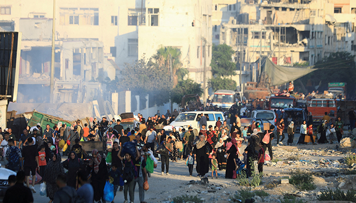 Palestinians, who fled the eastern part of Gaza City after they were ordered by Israeli army to evacuate their neighborhoods, carry their belongings, amid Israel-Hamas conflict, in Gaza City, July 7, 2024. — Reuters