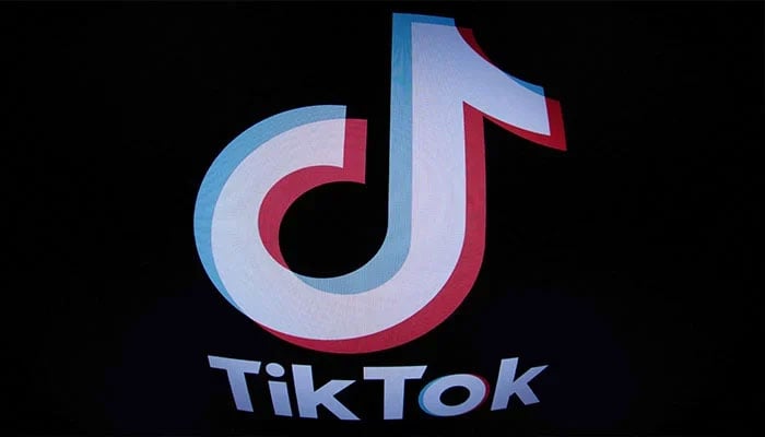 The logo of video-sharing site TikTok is seen on the screen with a dark background. — AFP/File