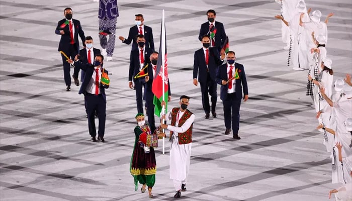 Farzad Mansouri and Kimia Yousofi of Afghanistan lead a contingent during the athletes parade at the opening ceremony of the Tokyo 2020 Olympic Games. — Reuters/File