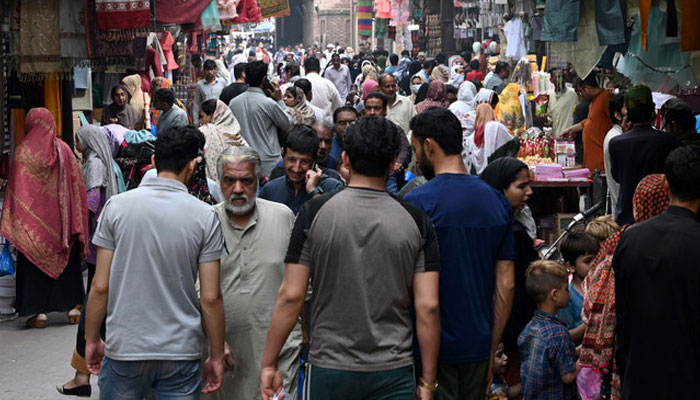 People throng a market area in Lahore, Pakistan on April 16, 2023. — AFP