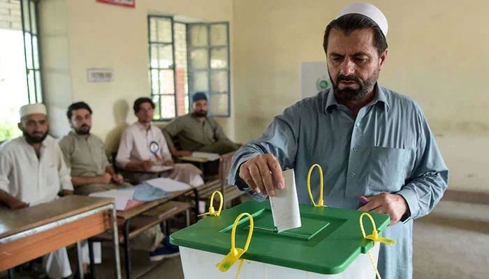 A tribesman ballot casts his vote in a polling station in KP. — AFP/File