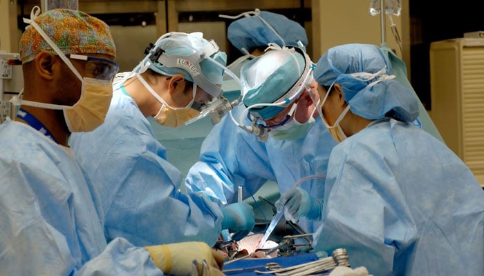 This representational image shows surgeons performing a surgery on a patient. — Unsplash