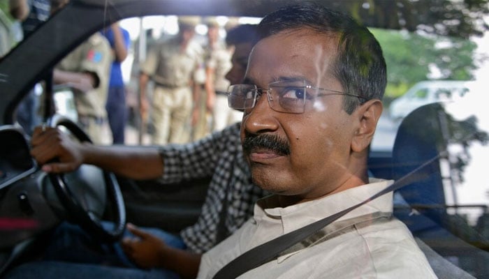 Arvind Kejriwal  looks out from inside his car as he arrives at a court in New Delhi May 21, 2014. — Reuters