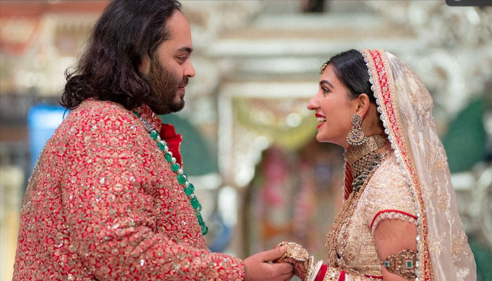 Anant Ambani, son of Indian billionaire Mukesh Ambani, and Radhika Merchant, daughter of industrialist Viren Merchant, react during their wedding celebrations in Mumbai, India, July 12, 2024. — Reuters