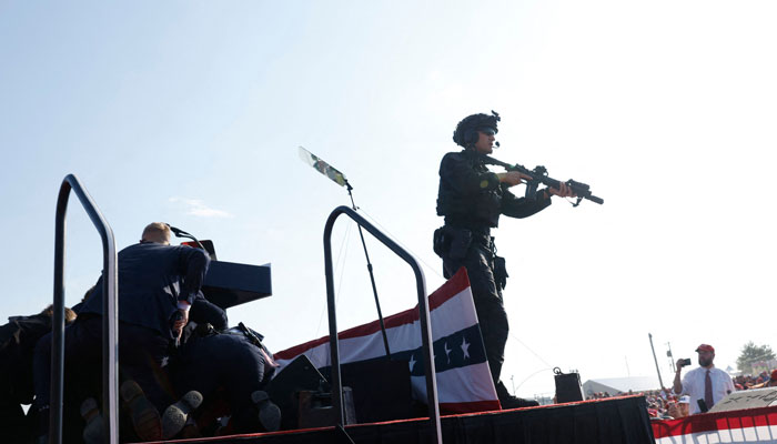 Security personnel stand alert after Republican presidential candidate former President Donald Trump is rushed offstage during a rally on July 13, 2024 in Butler, Pennsylvania. — AFP