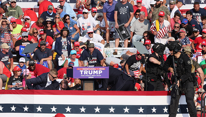 Republican presidential candidate Donald Trump is assisted by US Secret Service personnel after gunfire rang out during a campaign rally at the Butler Farm Show in Butler, Pennsylvania, US, July 13, 2024. — Reuters