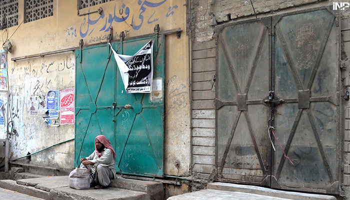 A man sits outside a flour mill as millers were on strike on July 11, 2024. — INP