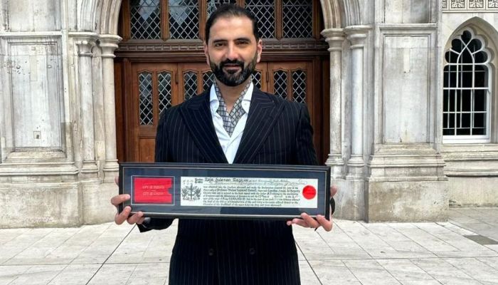 Suleman Raza poses with Freedom of the City of London award. — Reporter