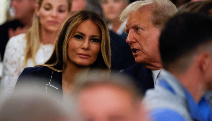 Former first lady Melania visible in the photo where Republican presidential candidate and former US president Donald Trump talks to her as they attend the 2024 Senior Club Championship award ceremony at his Trump International Golf Club in West Palm Beach, Florida on March 24, 2024. — Reuters