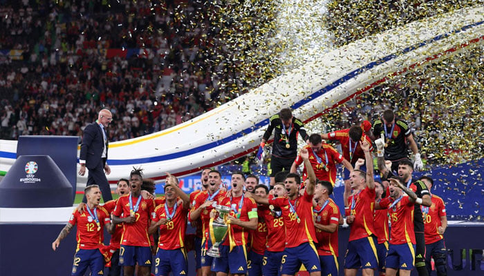 Spains forward Alvaro Morata holds the trophy and celebrates with teammates after winning the UEFA Euro 2024 final football match between Spain and England at the Olympiastadion in Berlin on July 14, 2024. — AFP