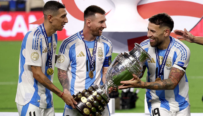 Argentinas Angel Di Maria (left), Lionel Messi (centre) and Nicolas Otamendi celebrate with the trophy after winning Copa America 2024 during final against Colombia at the Hard Rock Stadium in Miami, Florida, US on July 15, 2024. — Reuters