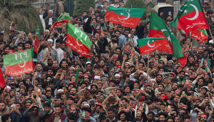 Supporters of PTI wave flags as they protest demanding free and fair results of the elections, in Peshawar, on February 17, 2024. — Reuters