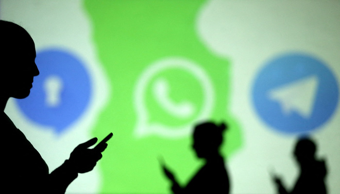 Silhouettes of mobile users are seen next to logos of social media apps Signal, Whatsapp and Telegram projected on a screen in this picture illustration taken March 28, 2018. — Reuters