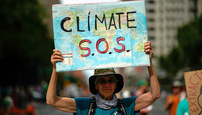 A man holds a sign as activists mark the start of Climate Week in New York during a demonstration calling for the U.S. government to take action on climate change and reject the use of fossil fuels in New York City, New York, US, September 17, 2023. — Reuters