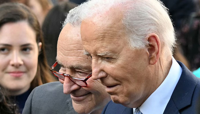 US President Joe Biden and Senate Majority Leader Chuck Schumer greet guests during an event. — AFP/File