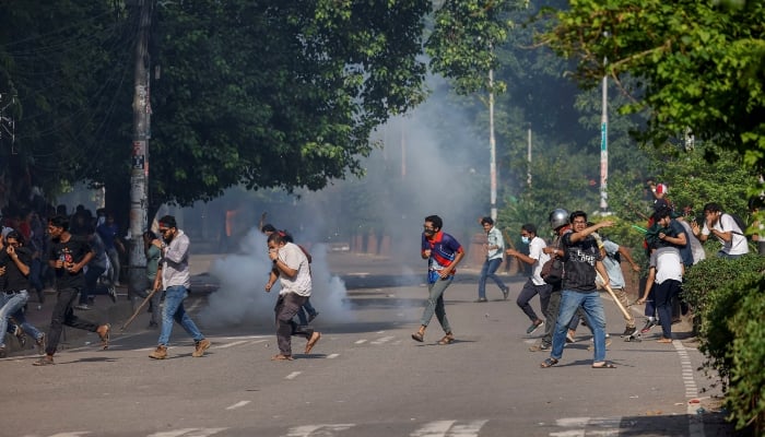 People run as police fire teargas during a coffin rally of anti-quota protesters at the University of Dhaka, in Dhaka, Bangladesh, on July 17, 2024. —Reuters