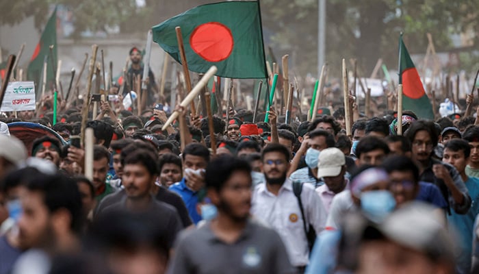 Anti-quota protesters march with Bangladeshi flags and sticks as they engage in a clash with Bangladesh Chhatra League, the student wing of the ruling party Bangladesh Awami League, at the University of Dhaka, in Dhaka, Bangladesh, July 16, 2024. — Reuters