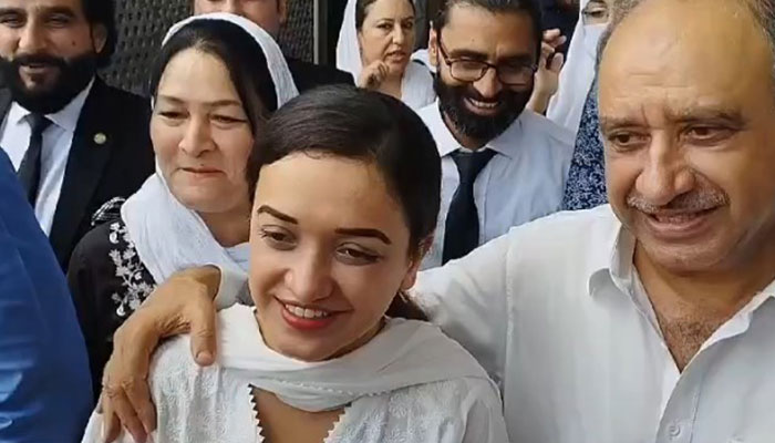 PTI activist Sanam Javaid pictured alongside her father in Islamabad on July 18, 2024. — Reporter