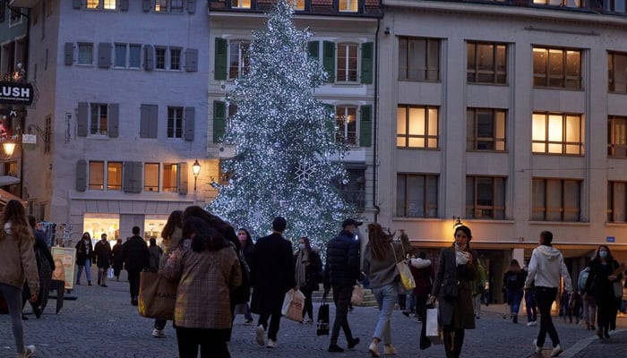 People walk along a shopping street during the coronavirus disease (COVID-19) outbreak in Lausanne, Switzerland, December 17, 2020. — Reuters