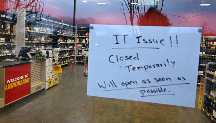 A sign notifies customers of a temporary closure due to IT issues at a store in Canberra, Australia, July 19, 2024. — Reuters