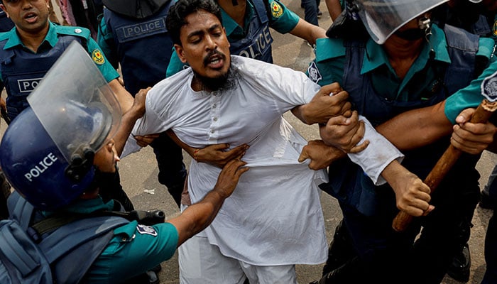 Police detains a man who was not leaving the University of Dhaka premises, a day after the clash between Bangladesh Chhatra League, the student wing of the ruling party Bangladesh Awami League, and anti-quota protesters, in Dhaka, Bangladesh, July 17, 2024. — Reuters