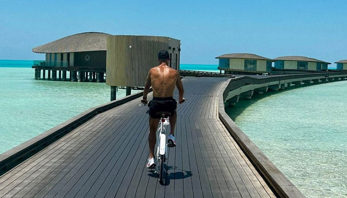 Cristiano Ronaldo rides a bike on a wooden boardwalk during vacation in Saudi Arabia. — Instagram/@cristiano